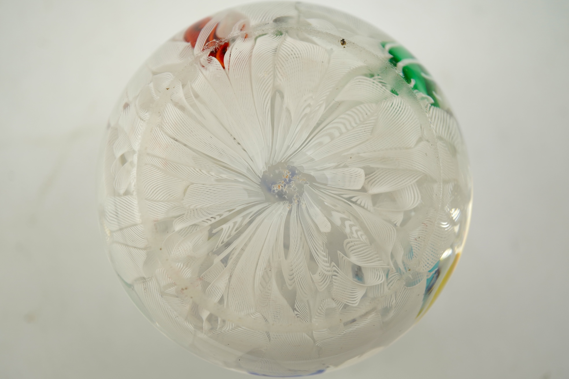 A Baccarat silhouette cane upset muslin ground paperweight, one cane dated 1848